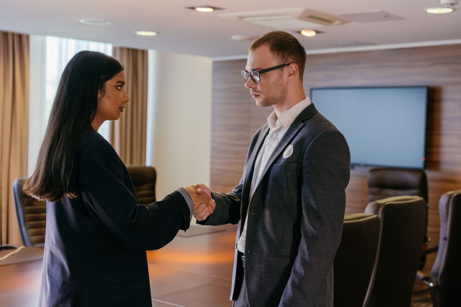 Two professionals shaking hands after a successful hire
