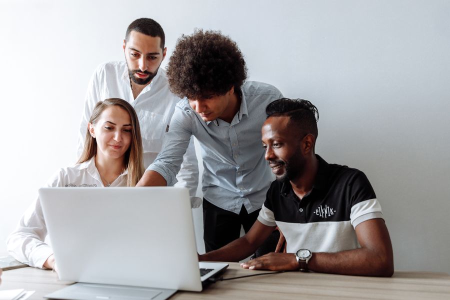 Business consultants discussing a strategy over a laptop