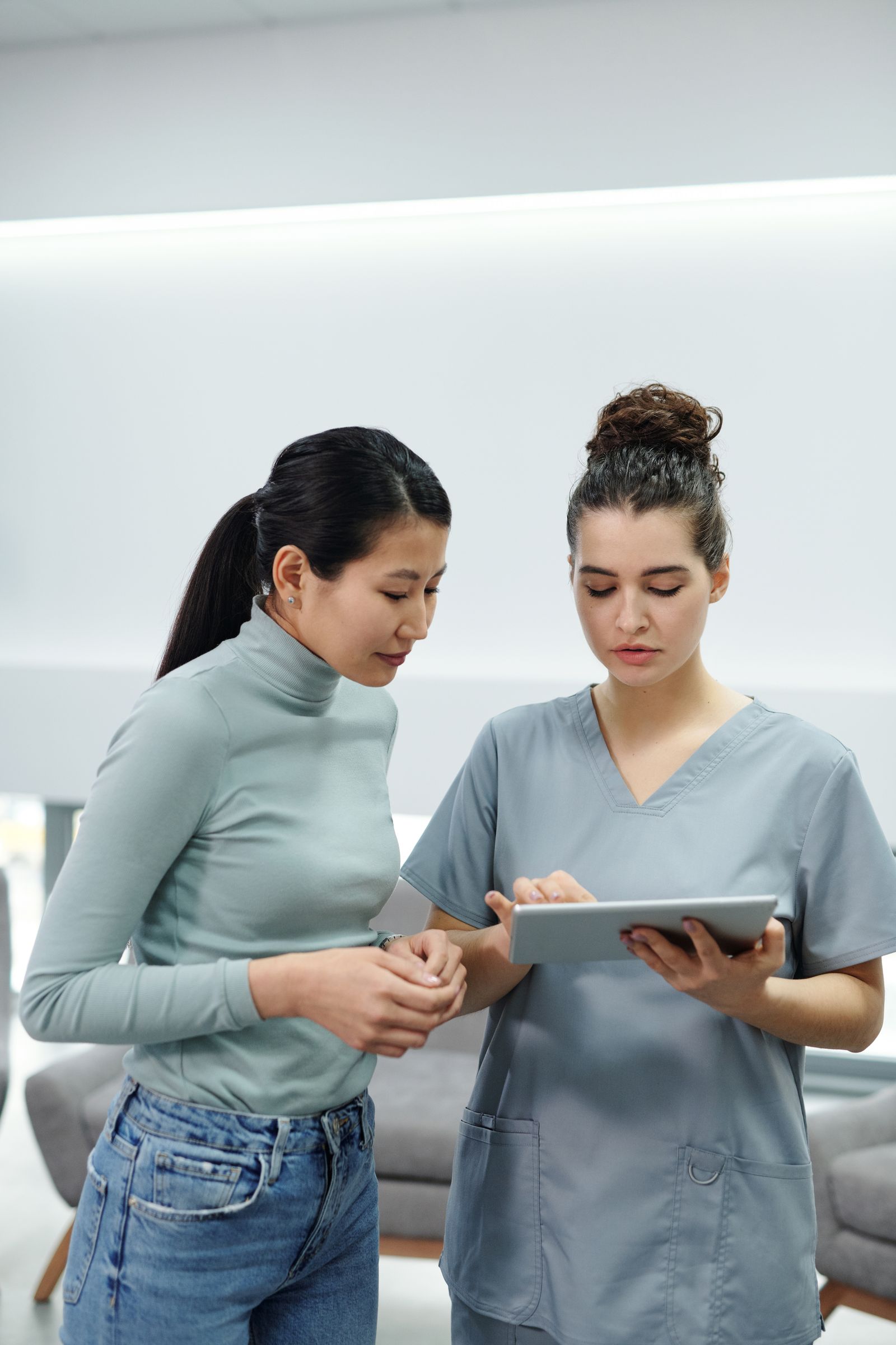 Clinician reviewing patient records on a digital tablet